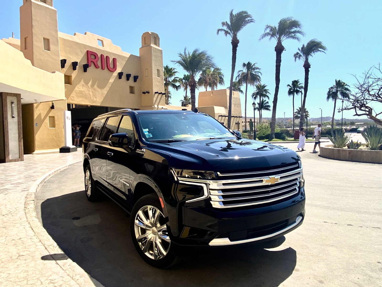 Riu Palace Los Cabos beachfront resort with SUV shuttle parked at the entrance